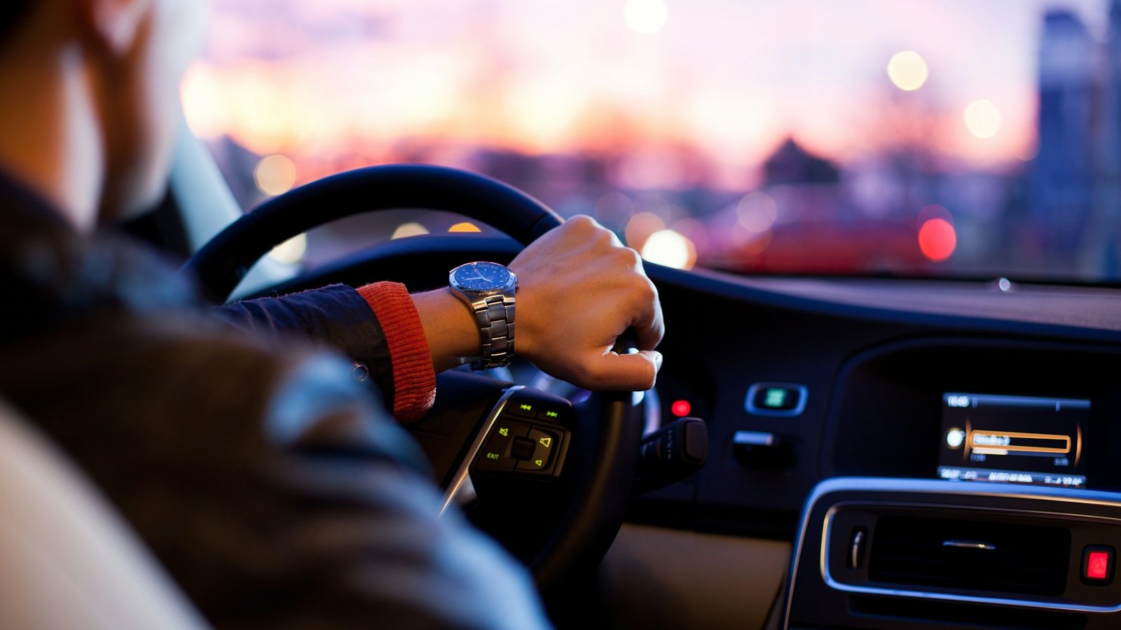 Dashboard view through a windshield on an open road — the license job starts with the drive.