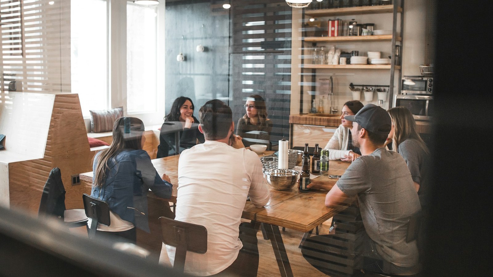 People working at a service counter in a bright office — find the DMV office before you go.